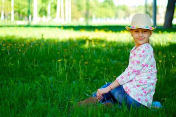 little girl with watering can in garden