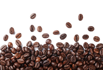 Falling roasted coffee beans isolated on white background.