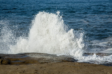 Water Hits and Splashes over Cliff Rocks