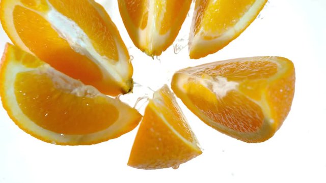 Super slow motion of orange slices with water splash. Filmed on high speed cinema camera, 1000 fps.
