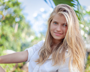 young happy blonde beautiful girl on tropical sea  background, smiling happy girl outdoor portrait