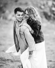 Beautiful couple on the background of a stone cliff. Portrait of a loving couple close up