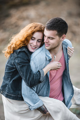 Fototapeta premium Portrait of a happy young couple enjoying a day in the park together