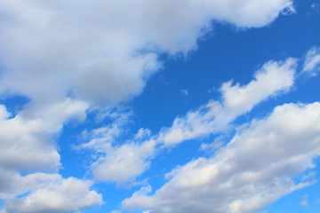 Naklejka na ściany i meble Blue sky and cumulus clouds. Background. Landscape.