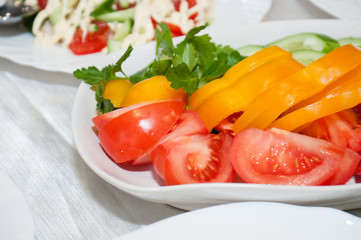 Vegetable sliced red tomato, yellow pepper on the holiday table. Birthday party