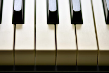 Naklejka premium Keys of a digital piano, soft focusing, creative mood of a person improvisation and creativity. Midi piano keyboard for playing digital music and making remixes.