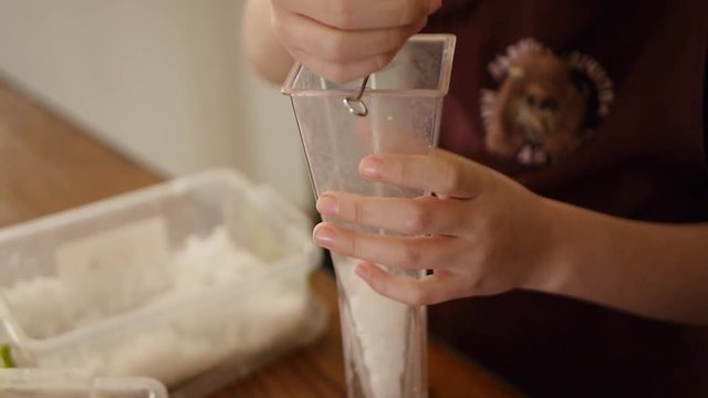 Making white candles indoors. Woman candle maker