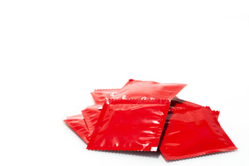 Stack of condom red packages with clipping path isolate on white background, preventive safe sex tool, rubber for sex.