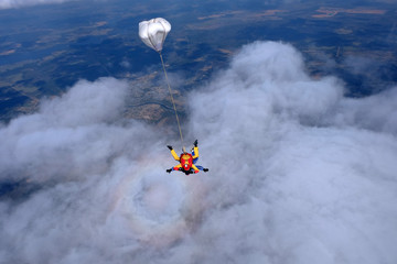 Fototapeta na wymiar Skydiving. Tandem jump. Happy passenger and his instructor.