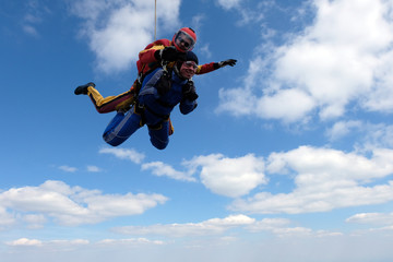 Fototapeta na wymiar Skydiving. Tandem jump. Happy passenger and his instructor.