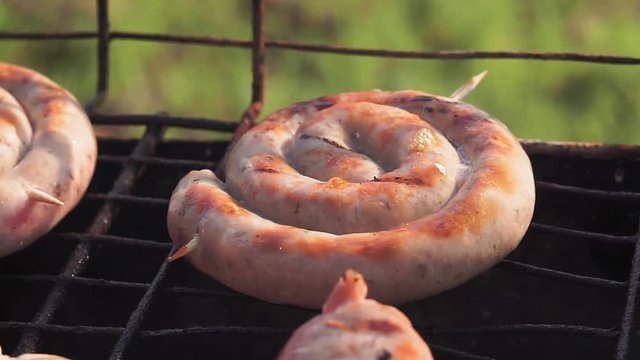 preparation of fried sausages on the grill