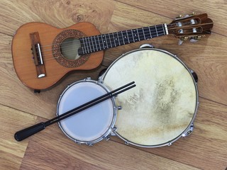 Three Brazilian musical instruments: cavaquinho, pandeiro (tambourine) and tamborim with drumstick...