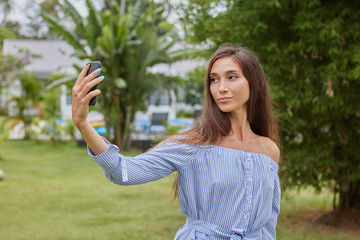 Girl in the park takes a selfie