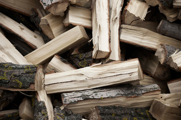 .Preparation of firewood for the winter. Firewood background. Stacks of firewood.