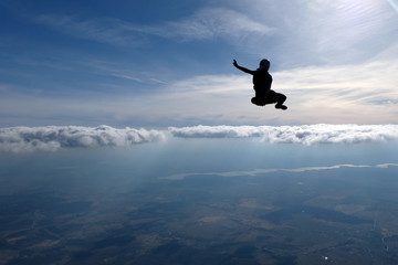 Skydiving. Girl is dancing in the sky.