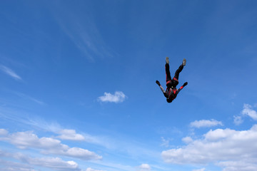 Naklejka na ściany i meble Skydiving. Girl is dancing in the sky.