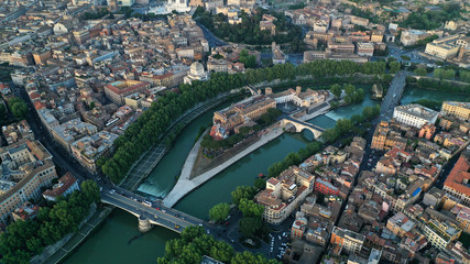 Fototapeta na wymiar Aerial view of hospital on the Tiber Island, on the Tiber River, Rome, Italy. Coliseum.