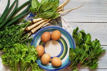 Obraz na płótnie Canvas Organic fresh vegetables and eggs. Source of vitamins and proteins. Cucumbers, parsley, quinoa and basil