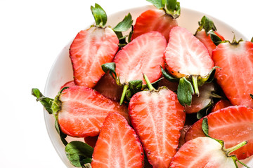 Freshly sliced strawberries. Plate with organic fresh strawberry slices for fruit salad.