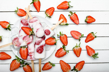 Natural juicy strawberry popsicles. Refreshing ice pops, overhead, flat lay