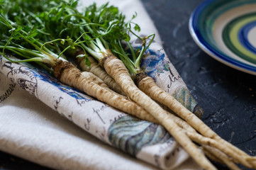 Bunch of parsley root with green leaves on a napkin