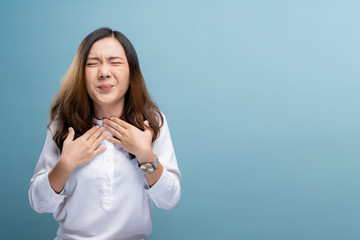 Woman has sore throat isolated over blue background