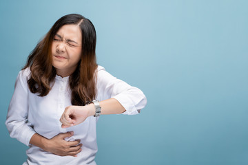 Woman has stomachache isolated over blue background