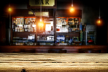 Fototapeta na wymiar Table background of free space and blurred background of bar 