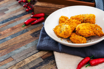 Chicken Wings Spicy chicken wings, breaded, fried, cooked.