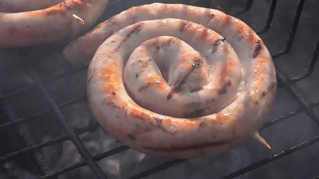 preparation of fried sausages on the grill