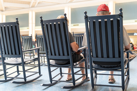 Retired Couple Relaxing In Rocking Chairs