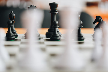 Chess pieces on a boart ready to play a game. Wood pieces of a game of chess on a board