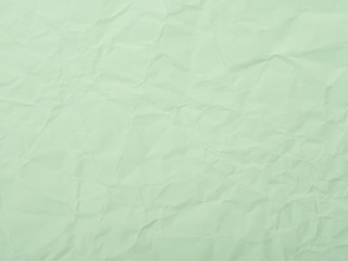 Green crumpled paper texture background
