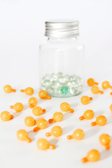 orange medical capsules with oil or medicine on a white background