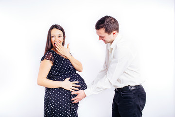 Surprised pregnant young woman waiting for her child with a surprised husband. 