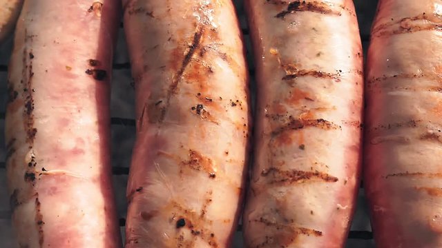 preparation of fried sausages on the grill