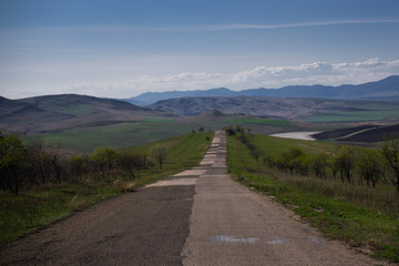 Fototapeta na wymiar long patchwork road through caucasus