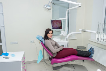 Smiling woman patient in dentistry after stomatological procedures