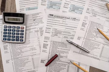 Calculator on 1040 tax form close up