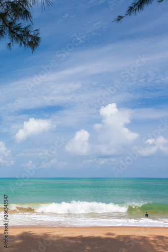 Little Boy Surfing In The Blue Sea In Sunny Day White Sand