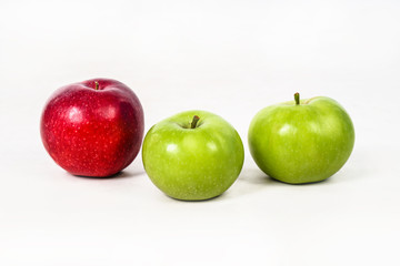 Red and green apples juicy and on a white isolated background. Vegetarian food. Stock photo