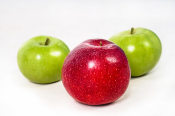 Red and green apples juicy and on a white isolated background. Vegetarian food. Stock photo