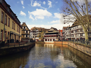 Fototapeta na wymiar Traditional timbered houses near the river in romantic city Strasbourg, France.