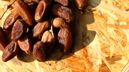 Dates in a wooden box under the afternoon sun