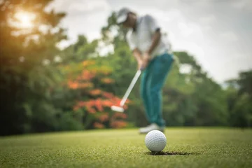 Rolgordijnen Golfer action to win after long putting golf ball on the green golf © somchai