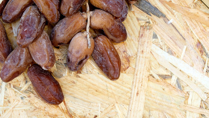 Dates in a wooden box under the afternoon sun