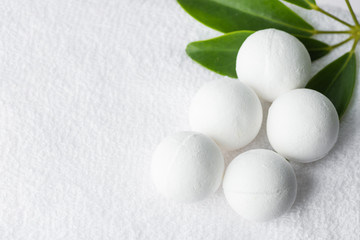 Handmade salt bath bombs in balls shape from organic vegan natural ingredients on white towel green...
