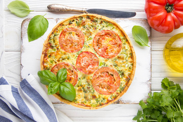 Quiche with vegetables (squash, tomatoes, cheese, herbs, green onions), open tart, French cuisine, traditional pastries