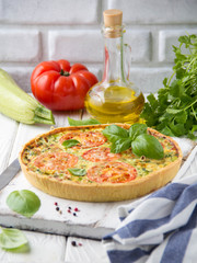 Quiche with vegetables (squash, tomatoes, cheese, herbs, green onions), open tart, French cuisine, traditional pastries