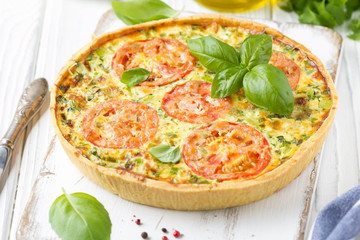 Quiche with vegetables (squash, tomatoes, cheese, herbs, green onions), open tart, French cuisine, traditional pastries